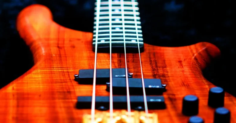 Flamed koa wood grain with a glossy Danish oil finish on a guitar body