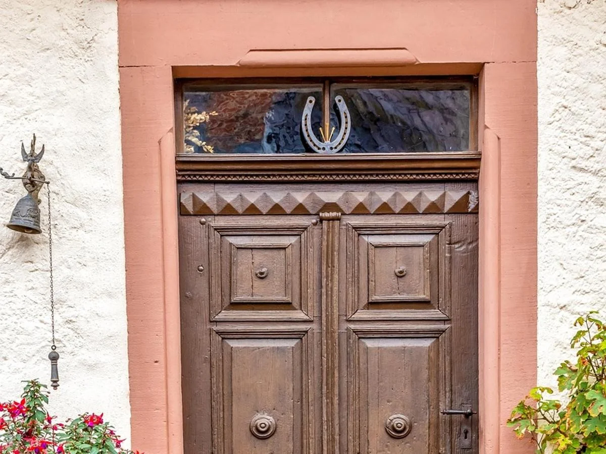 Solid wood paneled entry door with raised panels in a stone frame