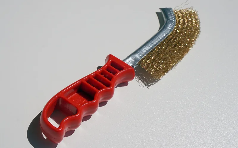 Wire wheel brush used for light rust removal on metal parts