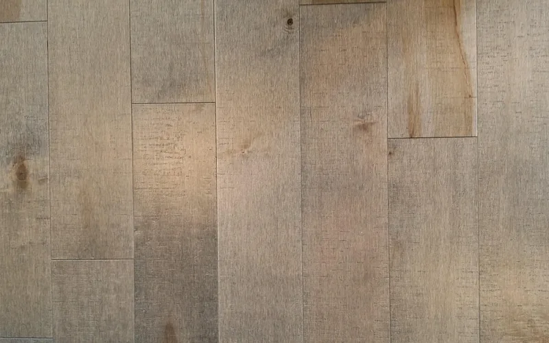 maple wood grain close-up close-up of light maple wood plank flooring showing tight, even grain
