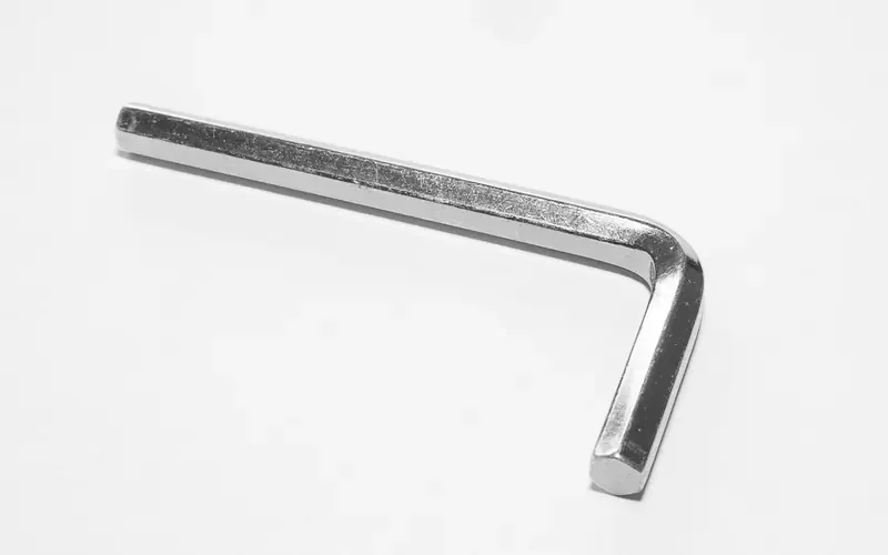 Single L-shaped hex key on a white background Single L-shaped hex key on a white background