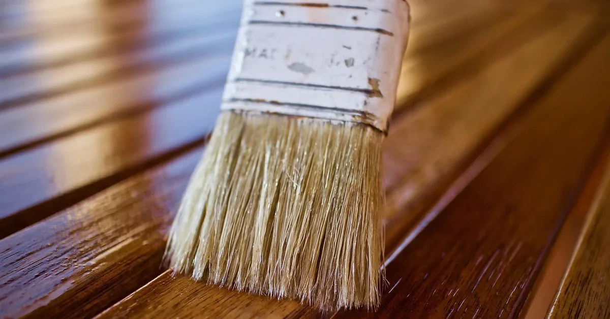 Natural bristle brush resting on a clear-coated wood board