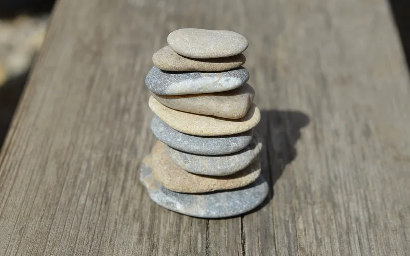 A smooth river rock resting on a wooden board before gluing A smooth river rock resting on a wooden board before gluing
