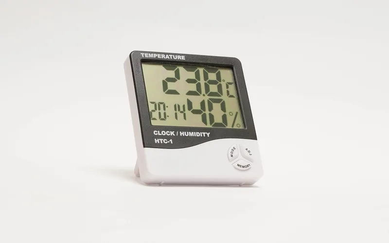 Digital hygrometer and thermometer used to monitor temperature and humidity inside a wood kiln Digital hygrometer and thermometer used to monitor temperature and humidity inside a wood kiln