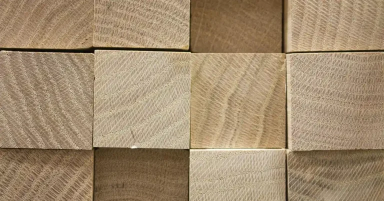 stack of squared 4x4 lumber posts showing end grain, ready for circular saw cutting