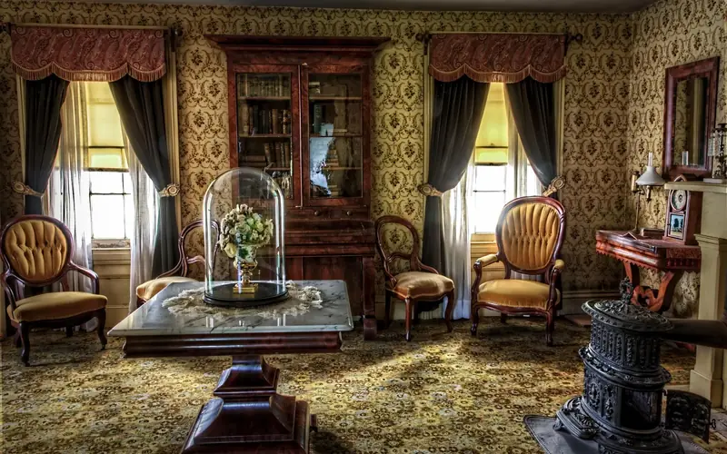 Victorian-era living room with dark carved antique wood furniture Victorian-era living room with dark carved antique wood furniture