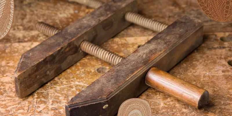 Antique wooden handscrew clamp showing the two-screw jaw design