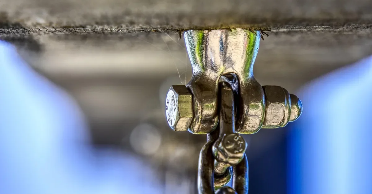 Steel shackle bolted to a wooden beam, an example of attaching metal to wood