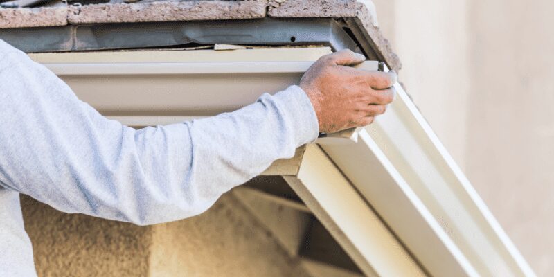 Aluminum trim edging attached to a wood board