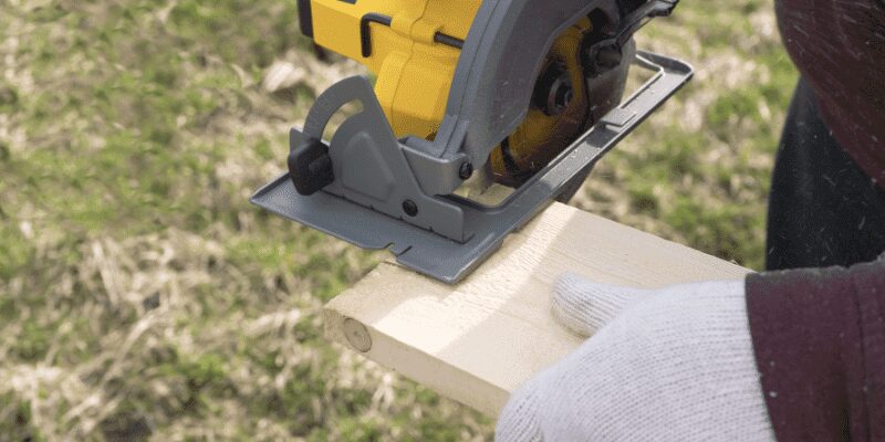 Circular saw guided by a clamped straightedge while ripping a board lengthwise Circular saw guided by a clamped straightedge while ripping a board lengthwise