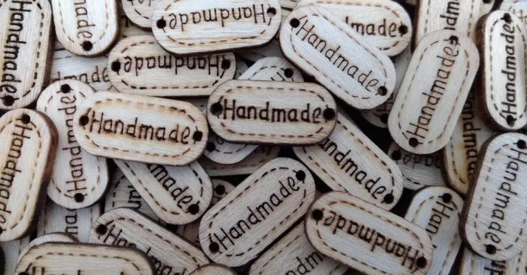 close-up of wood tags burned with the word Handmade using a pyrography pen