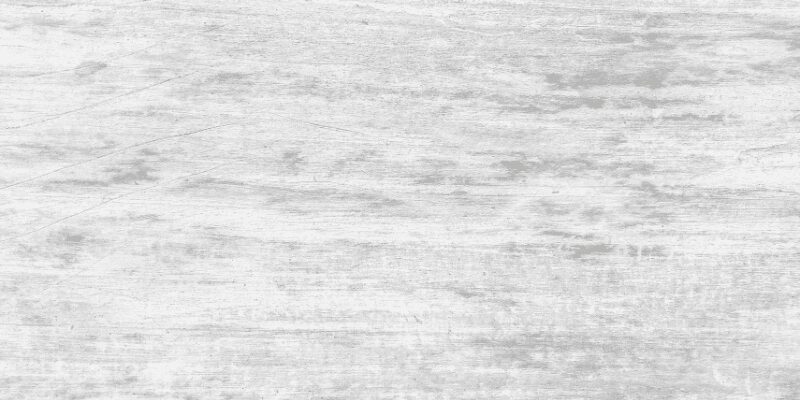Whitewashed barn wood boards showing the wood grain through a thin white finish