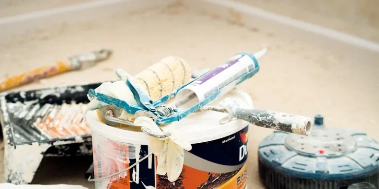 Applying caulk with a caulking gun during a trim renovation