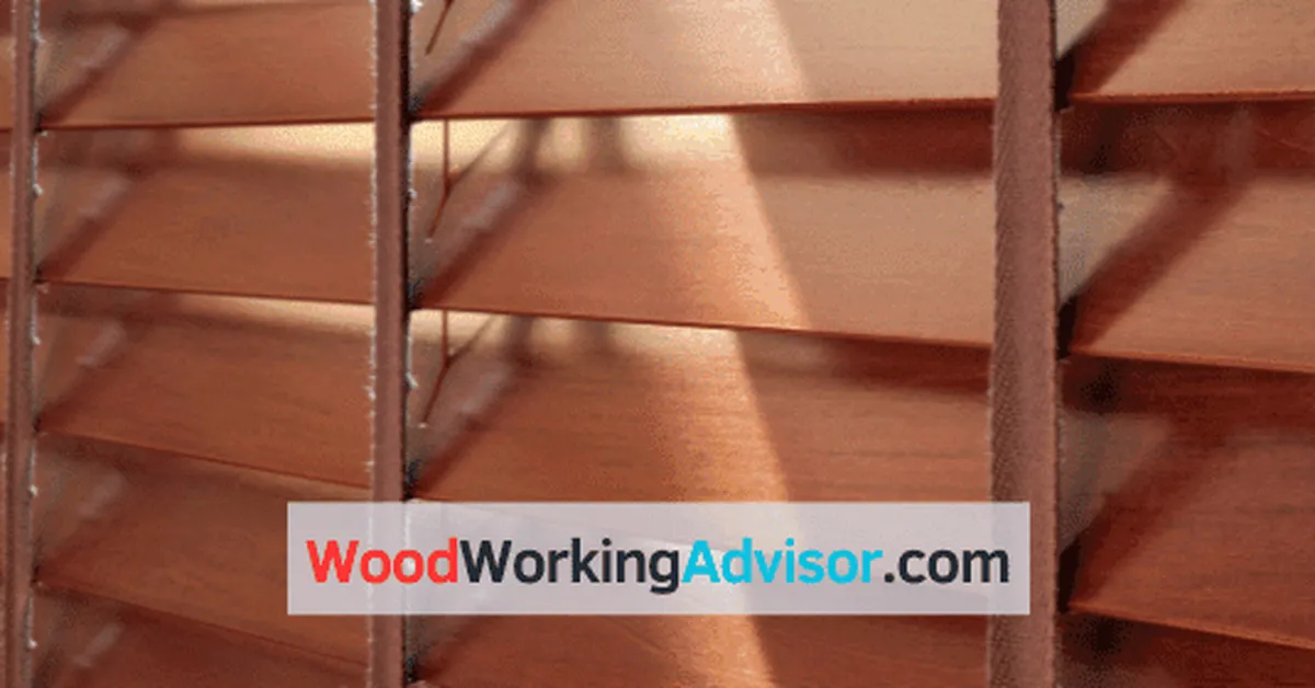 Close-up of wooden window blinds slats being cleaned with a microfiber cloth