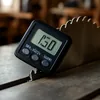 Digital angle gauge attached magnetically to a table saw blade to verify bevel angle