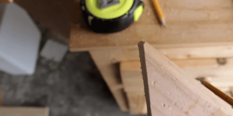 Board clamped at an angle on a table saw sled for a lengthwise cut