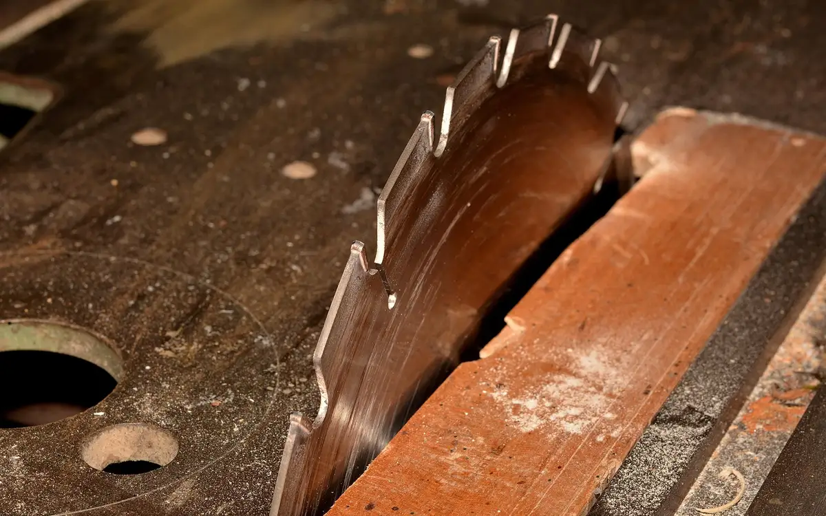 60-tooth carbide miter saw blade cutting through wood trim
