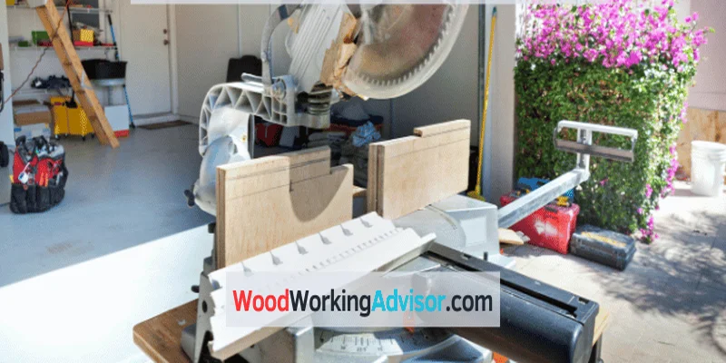 Single bevel miter saw set up in a garage workshop