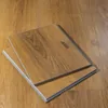 Two stacked 12-inch click-lock luxury vinyl plank samples in a warm oak tone