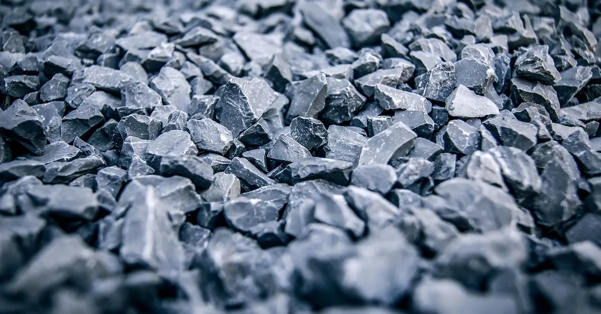 Close-up of blue-gray crushed stone used for a compacted shed gravel base