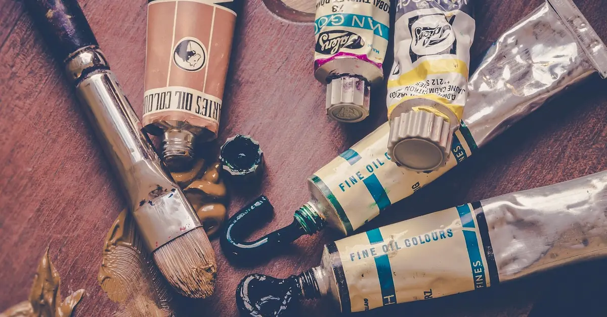 acrylic paint tubes and brush showing pigment and packaging