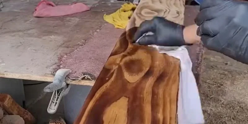 Applying water-based wood finish by hand with a cloth