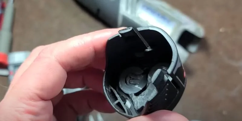Close-up of a cordless tool battery slot showing the rail and contact shape that must match the battery brand