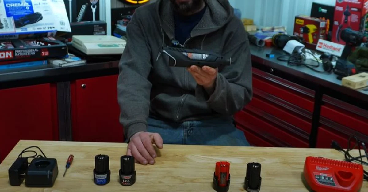 Comparing Bosch 12V and Milwaukee M12 batteries and chargers side by side on a workbench