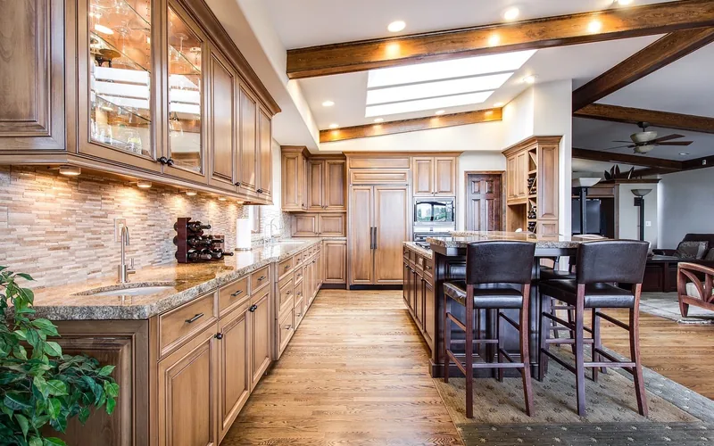 dark wood barstools contrasting a lighter wood floor in a kitchen