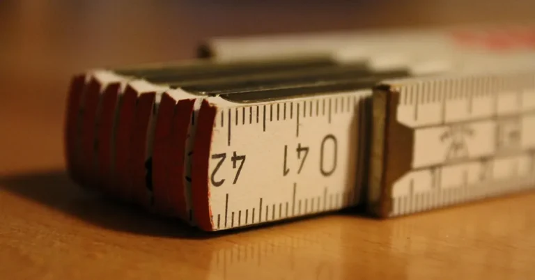 Folding wooden ruler lying on a workbench, used to measure hinge height and width