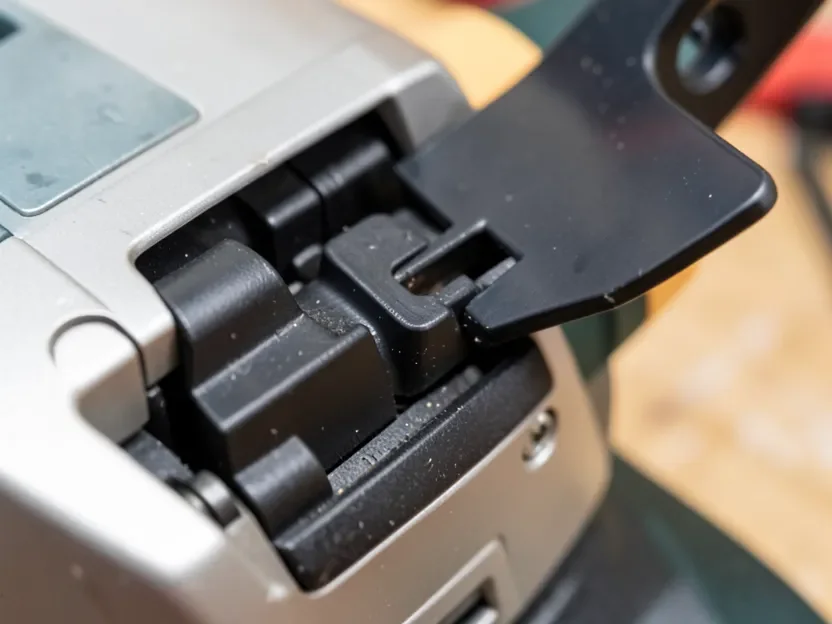 Tool-free jigsaw blade clamp lever open showing the T-shank slot