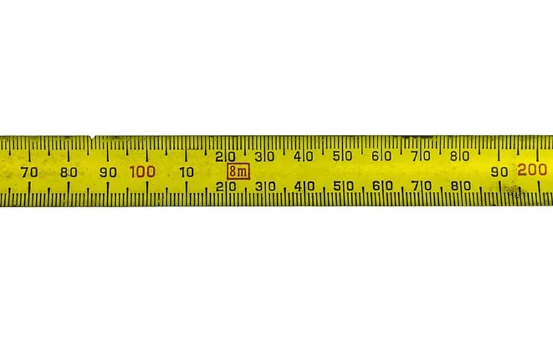 Measuring tape used to verify a marked cut length before making a 45-degree cut
