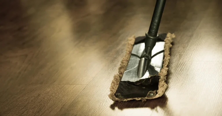 Microfiber flat mop pad gliding across a hardwood floor to clean it without scratching the paint