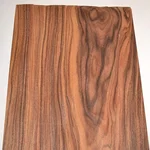 Santos rosewood raw wood veneer sheet showing dark reddish-brown grain with black streaks