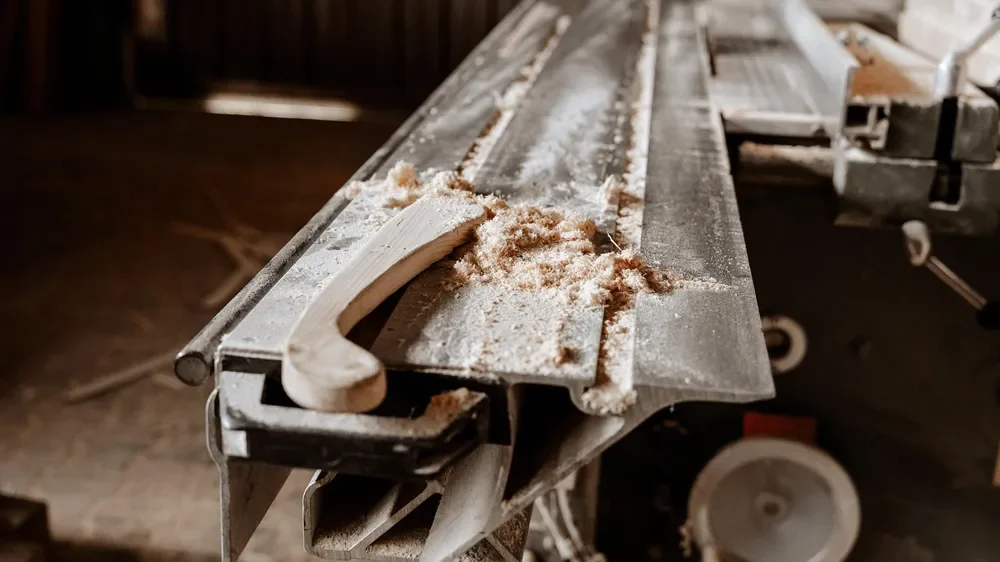 Fine sawdust and wood shavings on a workshop machine table Fine sawdust and wood shavings on a workshop machine table