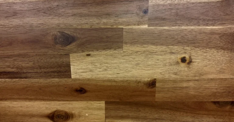 Close-up of American black walnut wood grain, showing its straight grain and medium-brown color used to compare against palisander rosewood