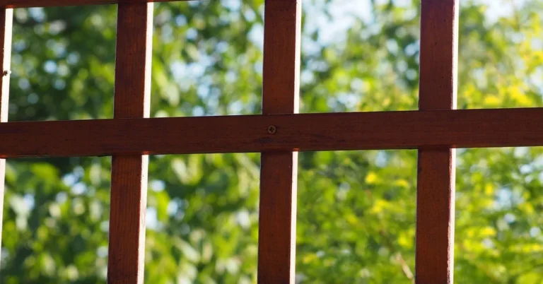 Wood lattice panel with square grid pattern mounted outdoors