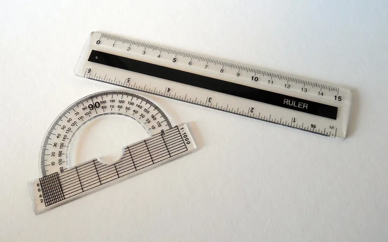Protractor measuring an out-of-square wall corner before setting the miter saw angle Protractor measuring an out-of-square wall corner before setting the miter saw angle