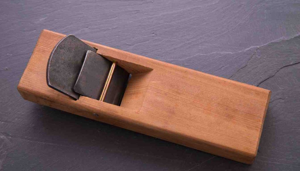 small block plane blade and chip breaker assembly resting on a slate surface