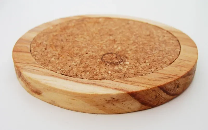 Wooden coaster with a cork center for protecting a wood table from drink rings Wooden coaster with a cork center for protecting a wood table from drink rings