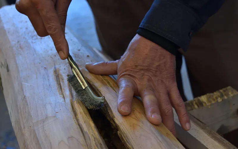 craftsman applying a hand finish to a wood piece before sale craftsman applying a hand finish to a wood piece before sale