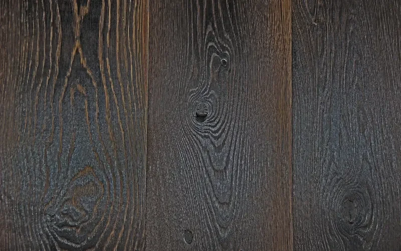 Close-up of dark hardwood floorboards showing grain and knots Close-up of dark hardwood floorboards showing grain and knots