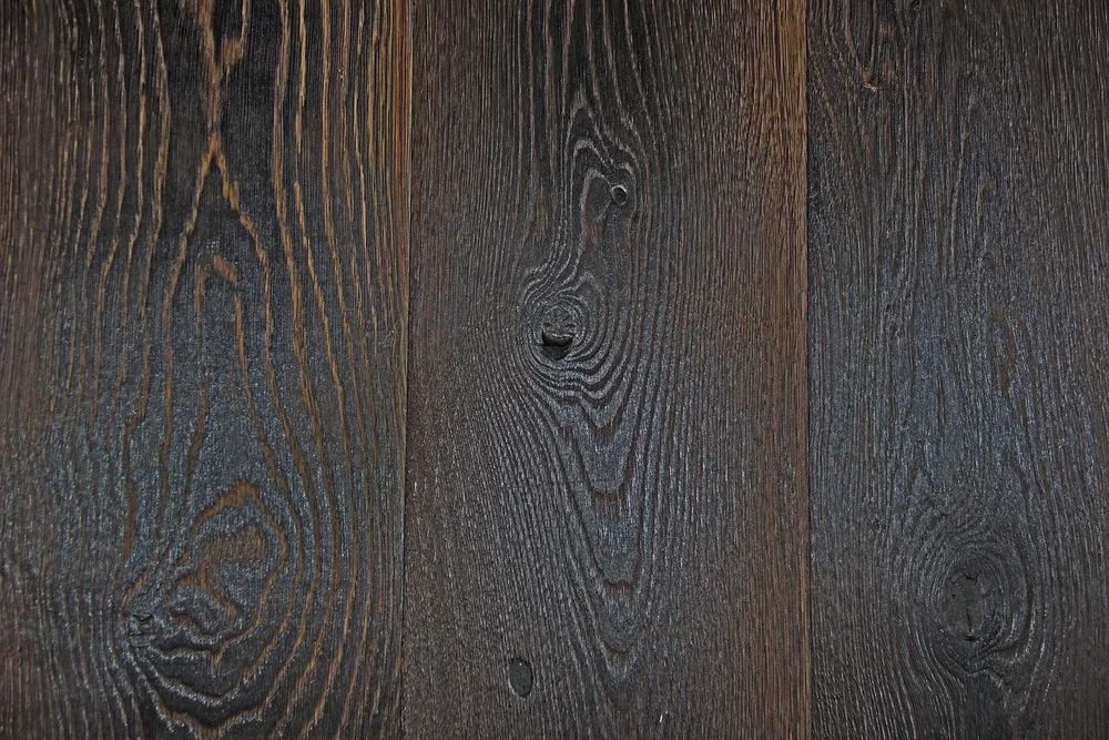 Close-up of dark hardwood floor planks showing grain and finish