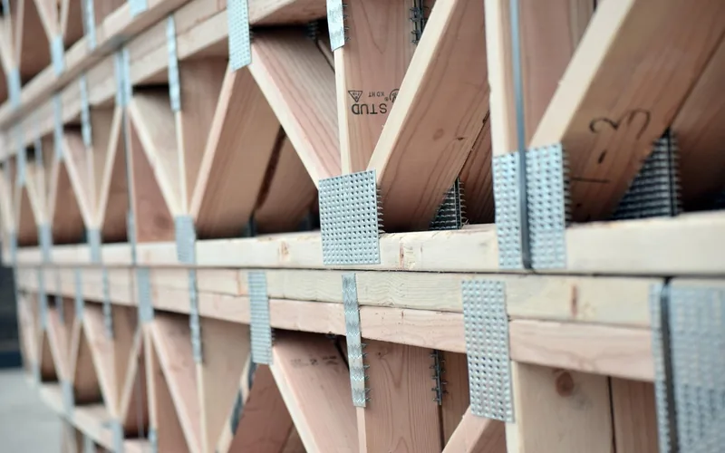Engineered wood I-joist floor trusses installed during residential framing Engineered wood I-joist floor trusses installed during residential framing