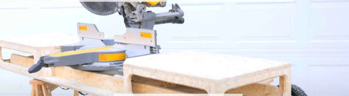 DeWalt miter saw mounted on a rolling stand with wheels in a home garage workshop