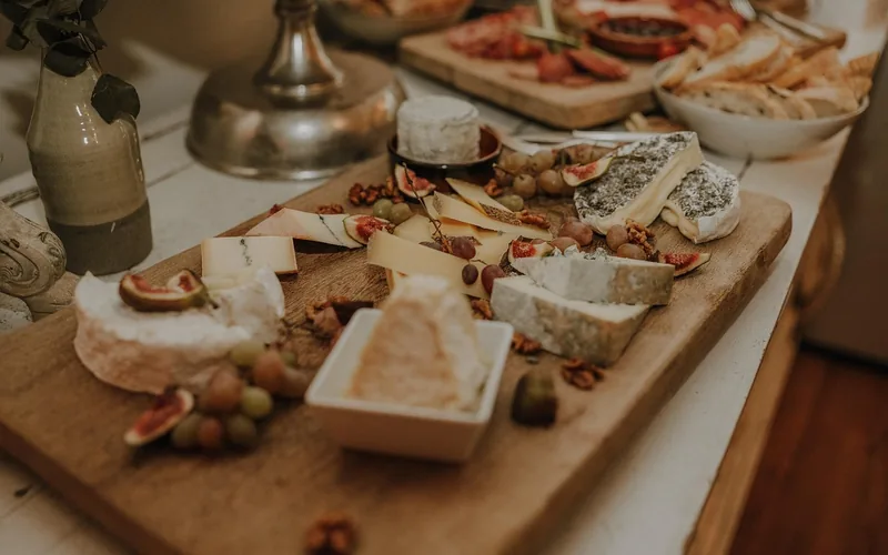 wooden charcuterie board finished with food-safe mineral oil, cheese and meats arranged on top