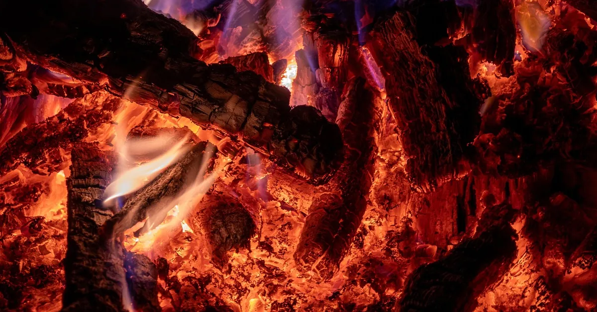 Glowing embers and flames in a wood fire