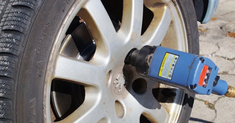 pneumatic impact wrench removing a lug nut from an aluminum wheel