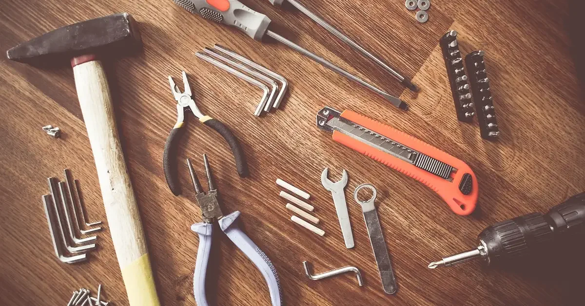 Hand tools laid out on a wooden workbench