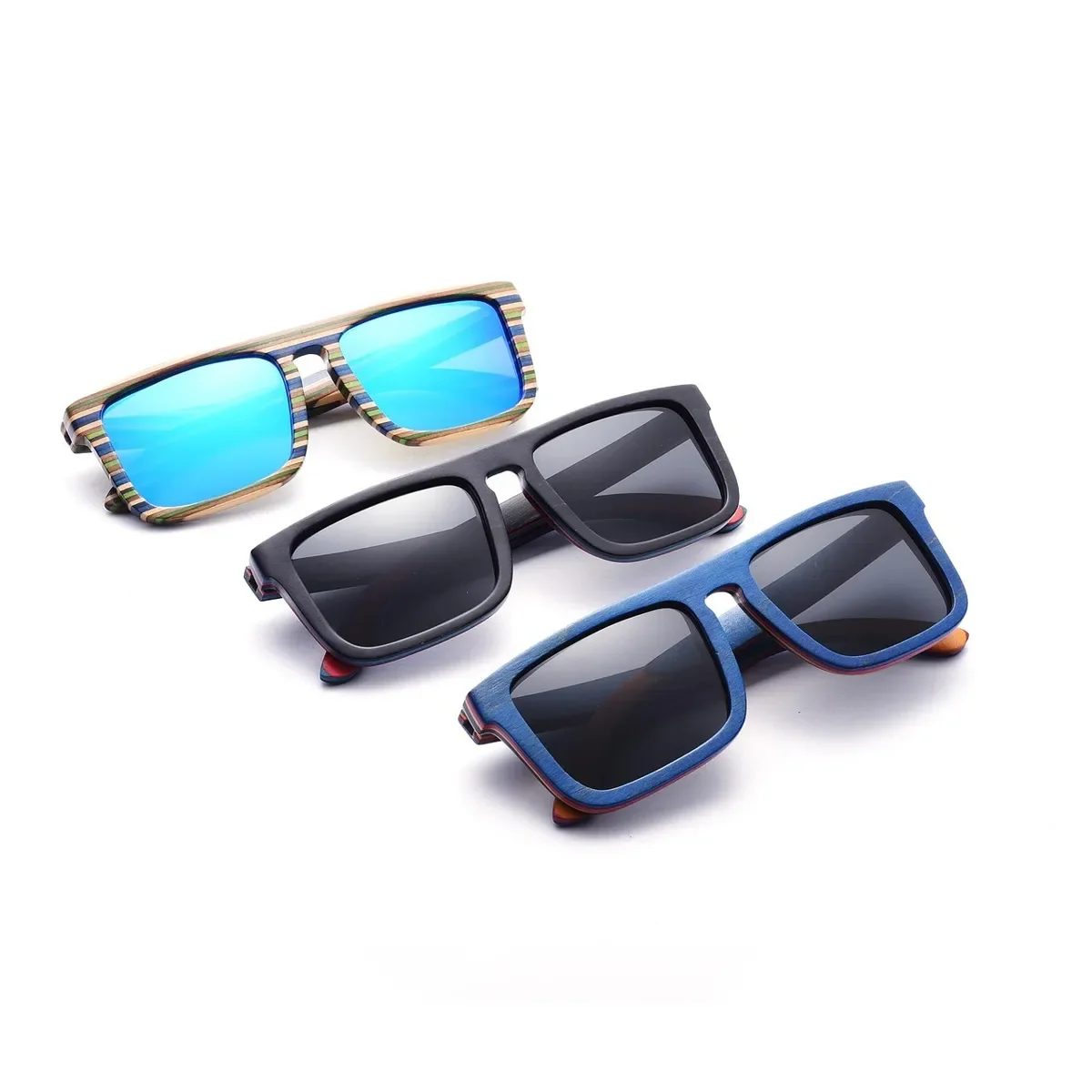 Three pairs of laminated wood sunglasses in blue, black and striped multicolor veneer